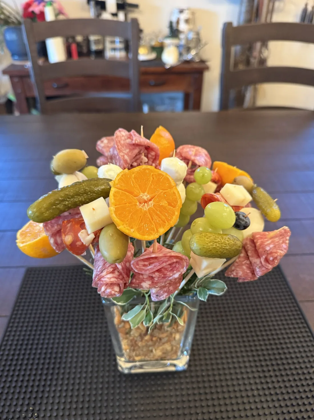 A charcuterie bouquet arranged in a glass vase