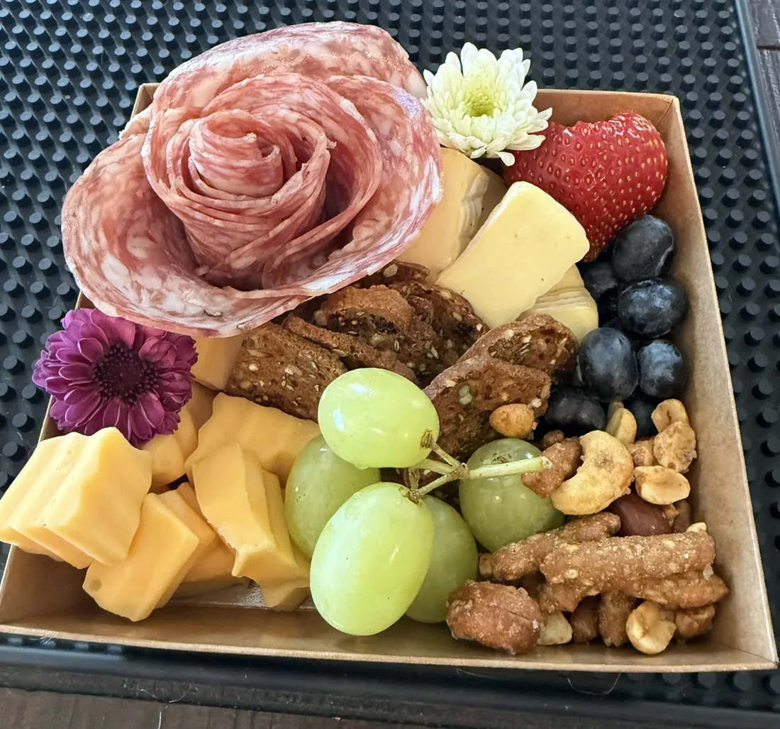 A single charcuterie box with a salami rose